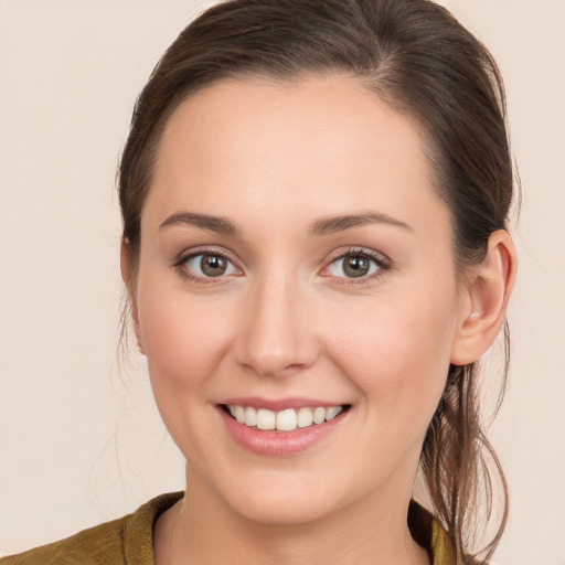 Joyful white young-adult female with long  brown hair and brown eyes