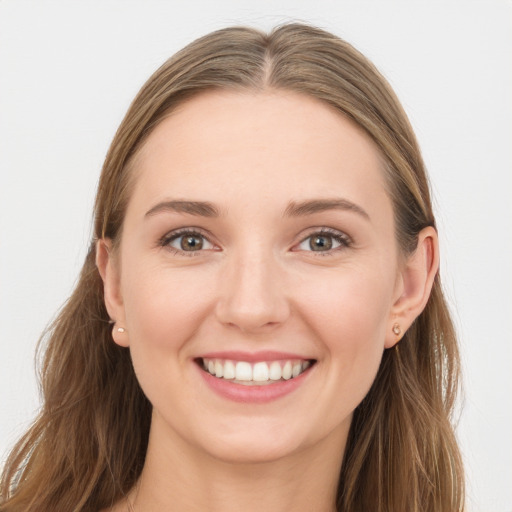 Joyful white young-adult female with long  brown hair and blue eyes