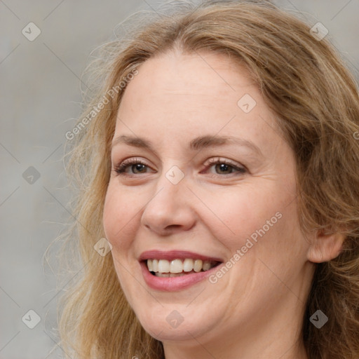 Joyful white adult female with long  brown hair and brown eyes