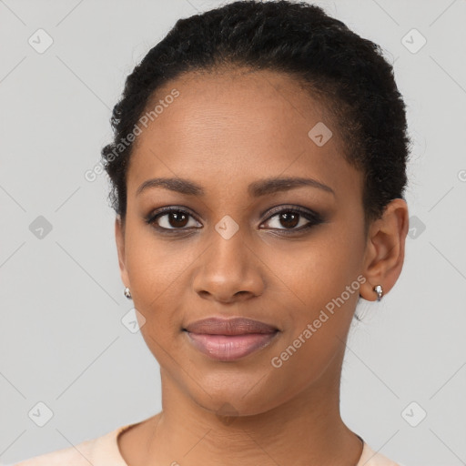 Joyful black young-adult female with short  brown hair and brown eyes