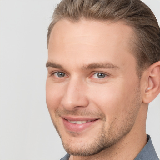 Joyful white young-adult male with short  brown hair and brown eyes