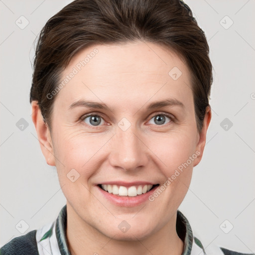 Joyful white young-adult female with short  brown hair and grey eyes