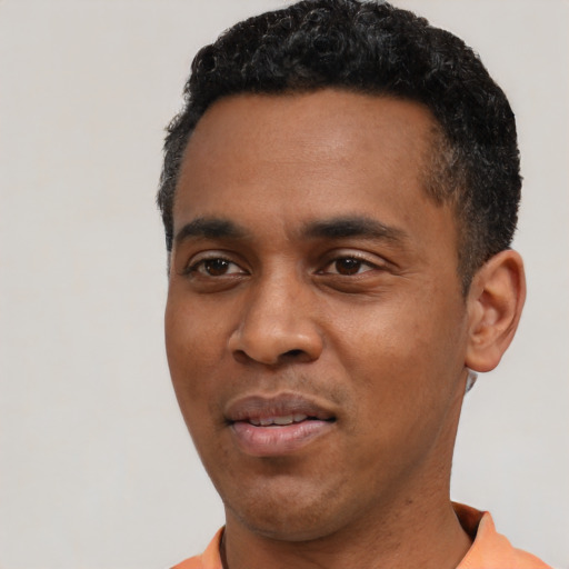 Joyful black young-adult male with short  black hair and brown eyes