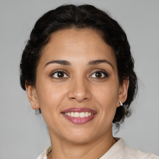 Joyful latino young-adult female with medium  brown hair and brown eyes