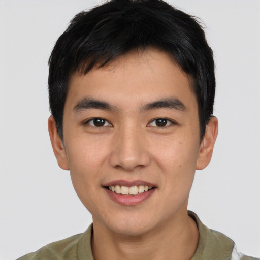 Joyful asian young-adult male with short  black hair and brown eyes