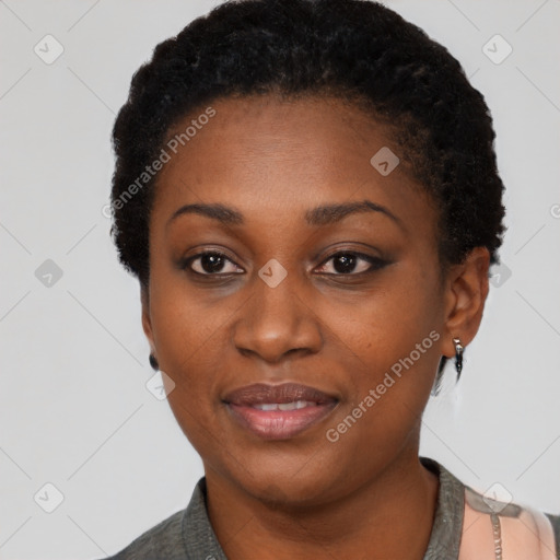 Joyful black young-adult female with short  black hair and brown eyes