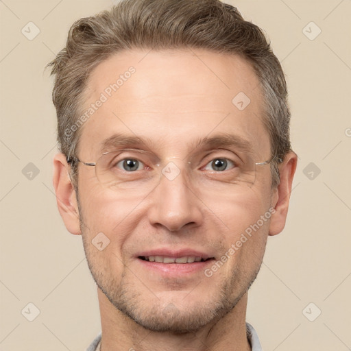 Joyful white adult male with short  brown hair and grey eyes