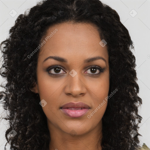 Joyful black young-adult female with long  black hair and brown eyes