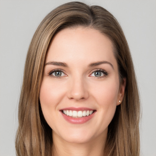 Joyful white young-adult female with long  brown hair and green eyes