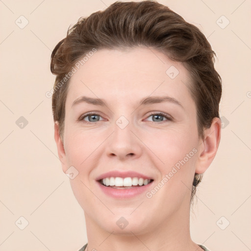 Joyful white young-adult female with short  brown hair and grey eyes