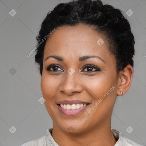 Joyful black young-adult female with short  black hair and brown eyes