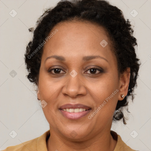 Joyful black adult female with medium  brown hair and brown eyes