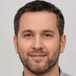 Joyful white adult male with short  brown hair and brown eyes