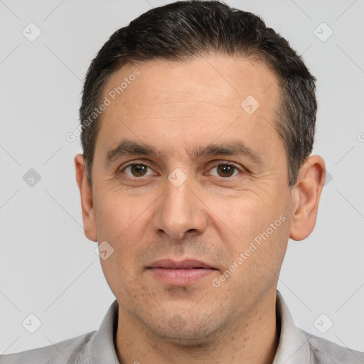 Joyful white adult male with short  black hair and brown eyes