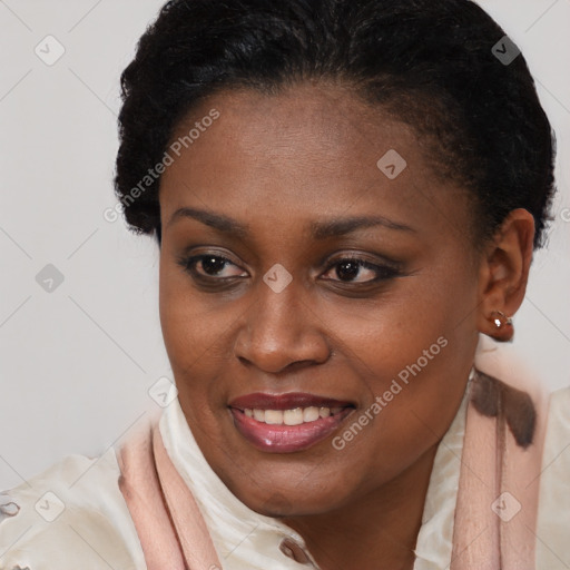 Joyful black young-adult female with short  brown hair and brown eyes