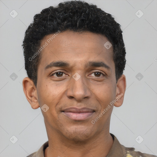 Joyful black young-adult male with short  black hair and brown eyes