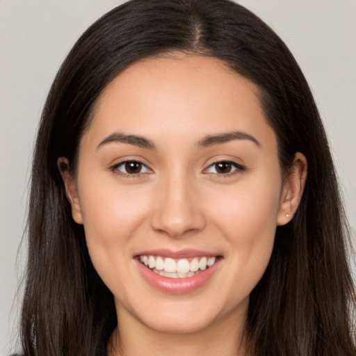 Joyful white young-adult female with long  brown hair and brown eyes