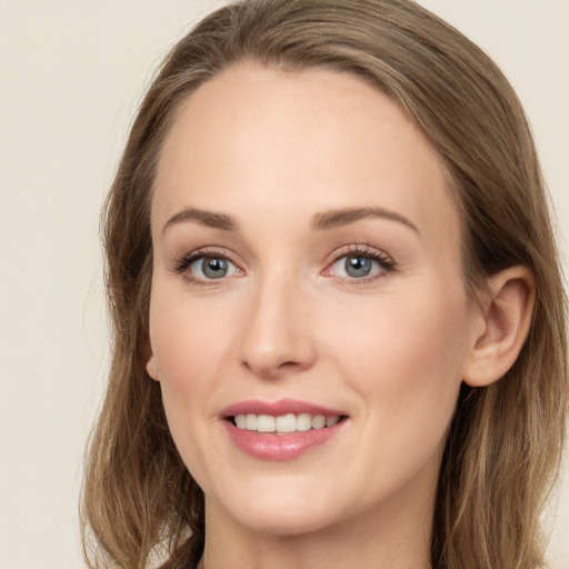 Joyful white young-adult female with long  brown hair and grey eyes