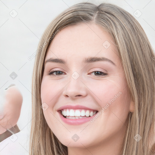 Joyful white young-adult female with long  brown hair and blue eyes