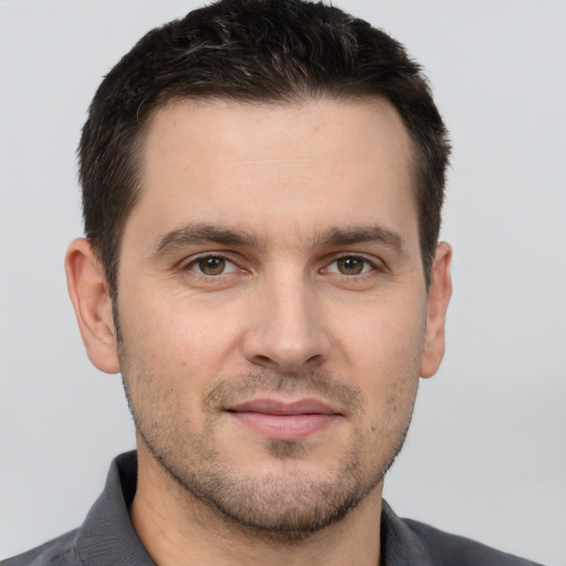 Joyful white young-adult male with short  brown hair and brown eyes