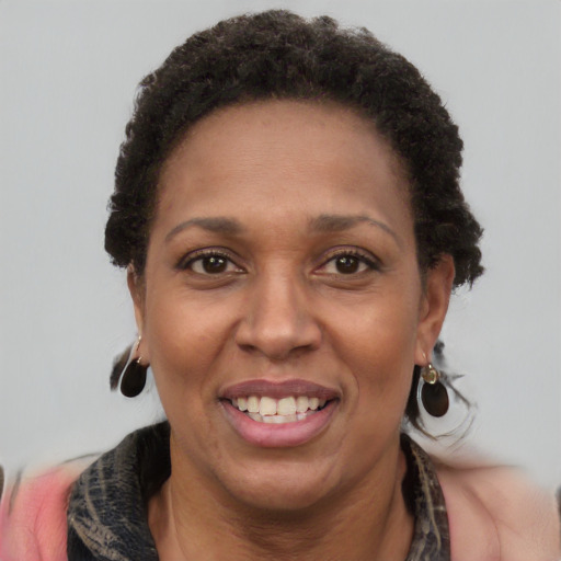 Joyful black adult female with short  brown hair and brown eyes