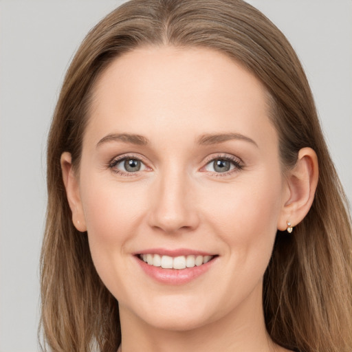 Joyful white young-adult female with long  brown hair and grey eyes