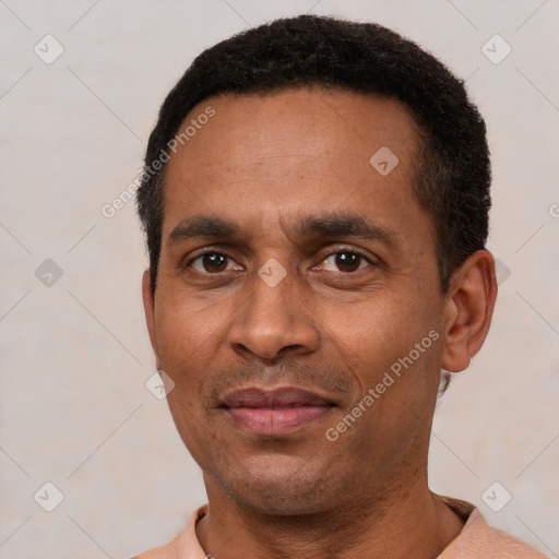 Joyful latino adult male with short  black hair and brown eyes