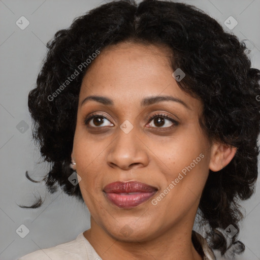 Joyful black adult female with medium  brown hair and brown eyes