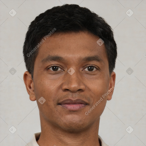 Joyful black young-adult male with short  brown hair and brown eyes