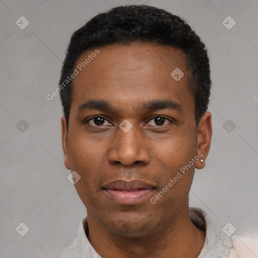 Joyful black young-adult male with short  black hair and brown eyes