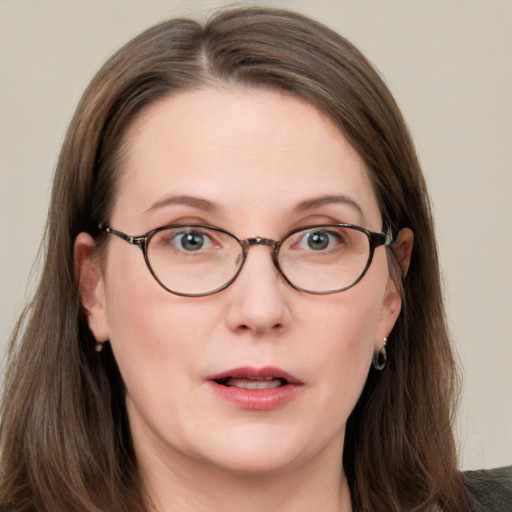 Joyful white adult female with long  brown hair and grey eyes