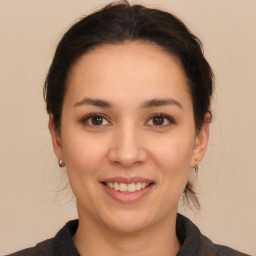 Joyful white young-adult female with medium  brown hair and brown eyes