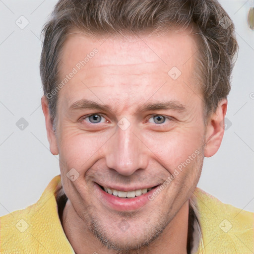 Joyful white adult male with short  brown hair and grey eyes