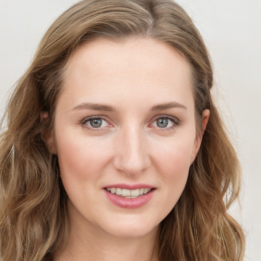 Joyful white young-adult female with long  brown hair and green eyes