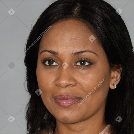 Joyful black adult female with long  brown hair and brown eyes