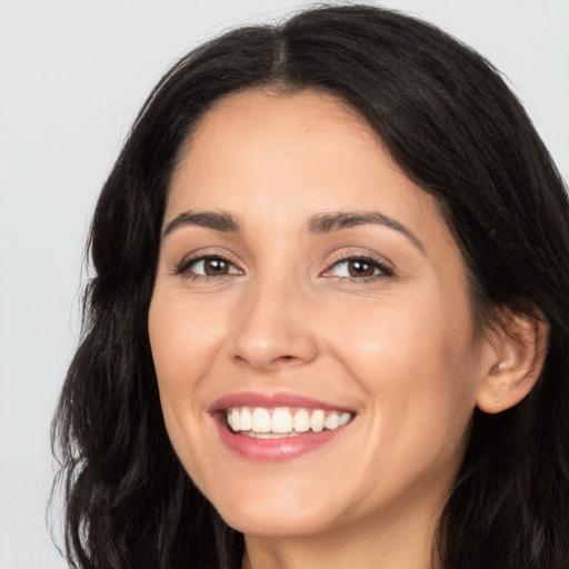 Joyful white young-adult female with long  black hair and brown eyes