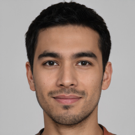 Joyful latino young-adult male with short  black hair and brown eyes