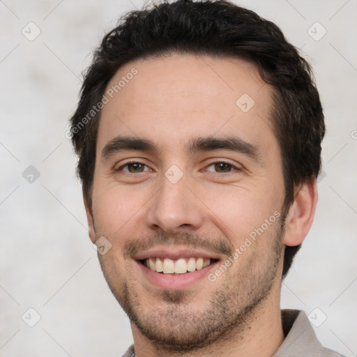 Joyful white young-adult male with short  black hair and brown eyes