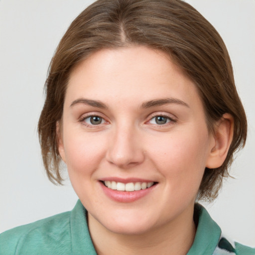 Joyful white young-adult female with medium  brown hair and blue eyes