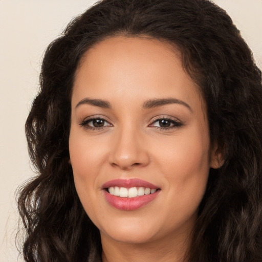 Joyful white young-adult female with long  brown hair and brown eyes