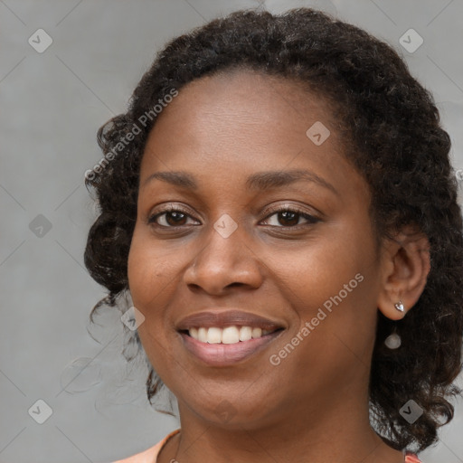 Joyful black young-adult female with medium  brown hair and brown eyes