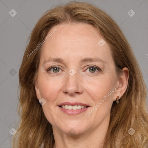 Joyful white adult female with long  brown hair and grey eyes