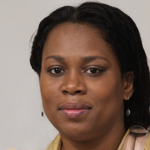 Joyful black adult female with medium  black hair and brown eyes