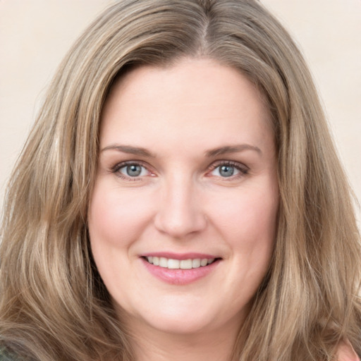 Joyful white young-adult female with long  brown hair and blue eyes