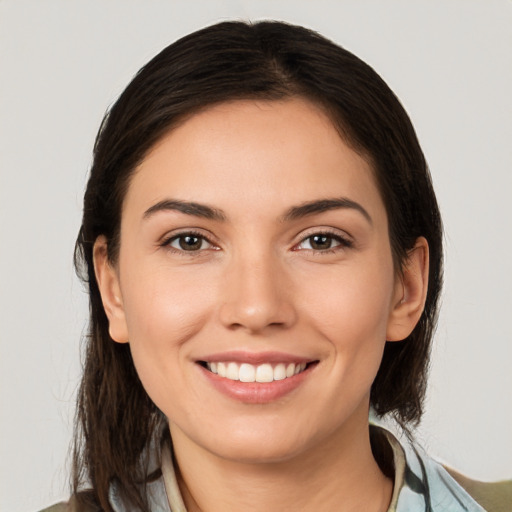 Joyful white young-adult female with medium  brown hair and brown eyes