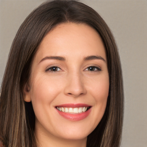 Joyful white young-adult female with long  brown hair and brown eyes