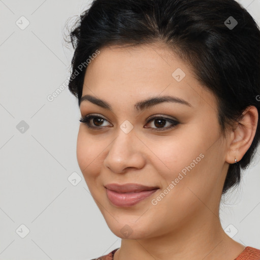 Joyful latino young-adult female with medium  brown hair and brown eyes