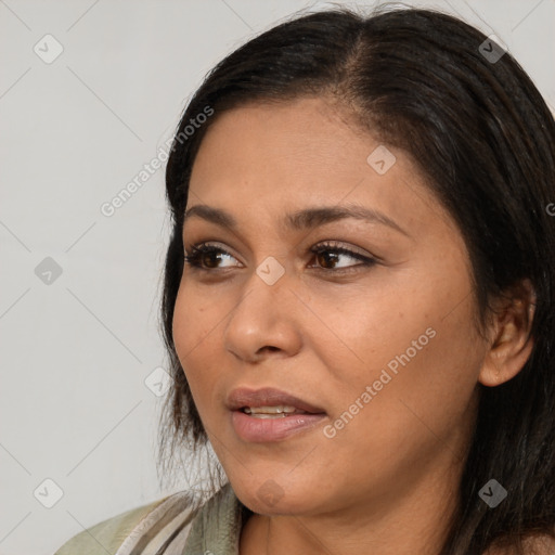 Joyful latino young-adult female with long  brown hair and brown eyes