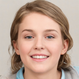 Joyful white child female with medium  brown hair and blue eyes