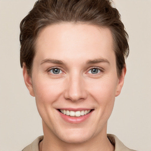 Joyful white young-adult female with short  brown hair and grey eyes